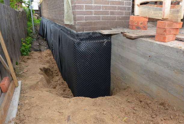 SJ Waterproofing Pros technician performing targeted Basement Waterproofing assessment in Great River, NY